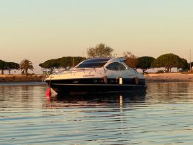 A sleek yacht docked in calm waters, reflecting the serene surroundings — perfect for luxury getaways or sunset cruises.
