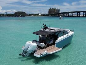 Aerial view of a sleek boat cruising through crystal-clear waters, showcasing its modern design and inviting atmosphere for a day on the water.