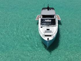 A stunning aerial view of a sleek yacht anchored in crystal-clear waters, showcasing its elegant design and perfect for luxury getaways.