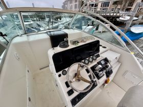 An interior view of a boat's helm and console, showcasing the controls and instruments essential for navigation.