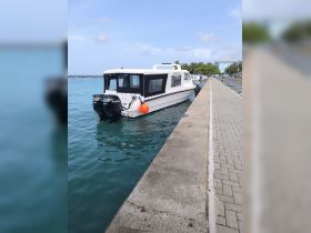 A sleek boat docked at the marina, showcasing its modern design and features — perfect for leisurely outings on the water.