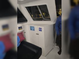 Interior view of a boat cabin featuring a bathroom area and seating, showcasing the amenities available for guests on board.