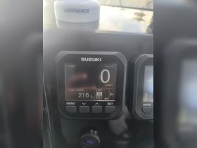 Close-up of a boat's dashboard displaying fuel usage and engine metrics, essential for monitoring performance during your maritime adventures.