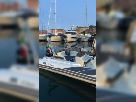 A sleek speedboat, the BSC 78 Classic, docked in a marina surrounded by other vessels, showcasing its modern design and inviting atmosphere.