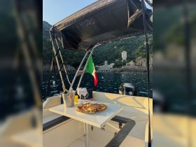 A beautifully arranged dining setup on a boat featuring a platter of delicious food and drinks, perfect for a relaxing day on the water.
