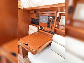 Interior view of a boat's helm area, showcasing the control panel and seating — perfect for navigating the open waters.