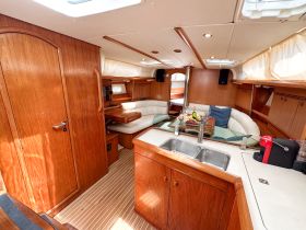 A beautifully designed boat interior featuring a spacious cabin with comfortable seating and modern amenities, perfect for relaxing during your nautical adventures.