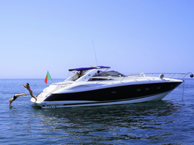 Two friends enjoy a refreshing jump into the ocean from a luxurious Sunseeker boat, capturing the essence of summer fun on the water.