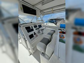 Interior view of a boat's helm area featuring modern controls and comfortable seating, ideal for navigating the waters.