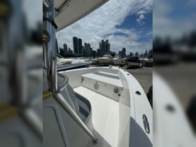 Interior view of a boat showcasing comfortable seating and helm area, perfect for a day out on the water.