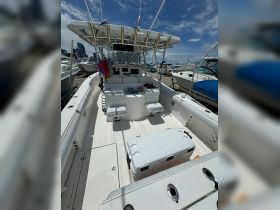 Interior view of a well-equipped boat featuring seating and a cooler, perfect for a day out on the water.