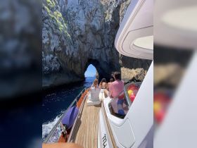 A group of friends enjoys a scenic boat ride through a stunning cave, capturing the essence of adventure and exploration on the water.