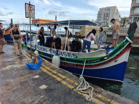 A lively group prepares for a diving adventure aboard the Sea Lion Cruises boat, showcasing the excitement of embarking on a marine exploration.