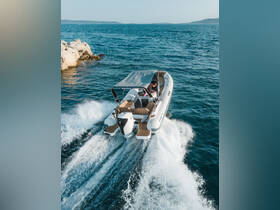 A sleek speedboat glides through the water, showcasing its dynamic design and performance. Perfect for thrilling adventures on the open sea.