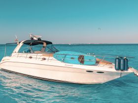 A stunning view of a sleek yacht cruising through clear turquoise waters, perfect for luxury charters and day trips.