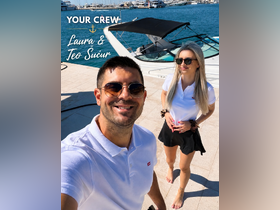 A cheerful crew poses for a selfie in front of their boat, ready to welcome guests for an exciting day on the water.