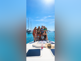 A vibrant group of friends poses for a fun photo on the deck of a yacht, celebrating summer under the sun — perfect for memorable outings and parties on the water.
