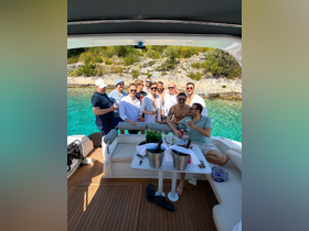 A lively group of friends celebrates aboard a boat, enjoying drinks and the beautiful surroundings — perfect for unforgettable summer parties on the water.