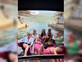 A group of friends enjoys a sunny day on a boat, capturing the essence of fun and friendship on the water.