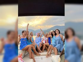 A lively group of friends celebrates a birthday on a boat at sunset, creating unforgettable memories with laughter and joy.