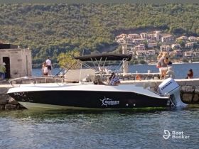 A scenic view of a boat named 'Seatours' docked with people enjoying the waterfront, making it a perfect spot for relaxation and exploration.