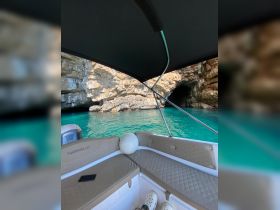 A cozy view of the interior seating area of a Marinello boat, showcasing the elegant design and inviting atmosphere, perfect for a day on the water.