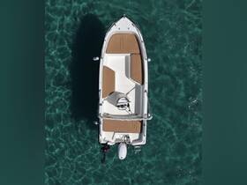 Aerial view of a sleek center console boat gliding through crystal-clear waters, perfect for day trips and water adventures.