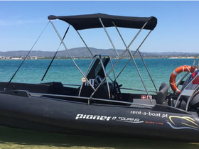 A sleek Pioneer 17 Touring speedboat docked in clear waters, showcasing its modern design and perfect for leisurely outings.