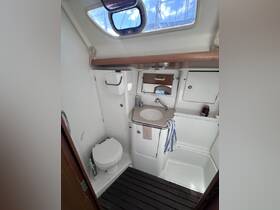 Interior view of a boat bathroom featuring a toilet, sink, and storage — a functional space designed for comfort while at sea.