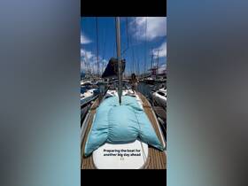 A person prepares the boat for another exciting day ahead at the marina, showcasing the vibrant atmosphere of sailing adventures.