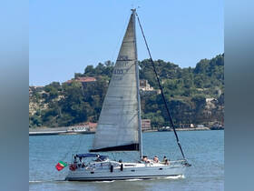 A lively group enjoys a sailing adventure on a beautiful day, showcasing the joy of being on the water aboard a sleek sailboat.