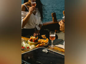 A beautifully arranged platter of fresh fruit and cocktails on a boat, perfect for enjoying a relaxing day on the water.