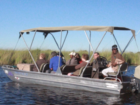 A group of guests enjoys a scenic boat tour, exploring the waterways surrounded by lush greenery — perfect for nature enthusiasts.