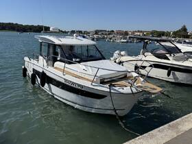 A sleek boat docked in calm waters, showcasing its modern design and features — perfect for leisurely outings or fishing trips.