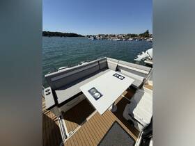 A stylish dining area inside a boat featuring comfortable seating and a table, perfect for enjoying meals while cruising on the water.