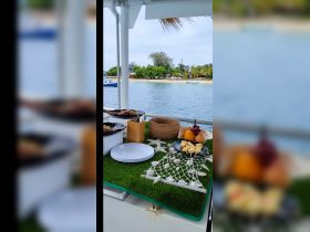 A beautifully arranged spread of food and drinks on a boat, perfect for enjoying a relaxing day on the water with friends or family.