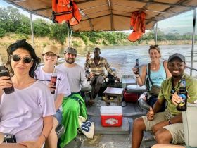 A cheerful group enjoys drinks aboard a boat, capturing the essence of fun and camaraderie on the water.
