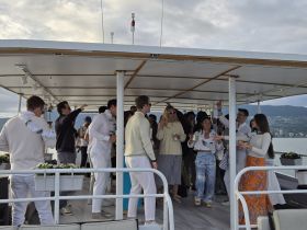 A lively group celebrates aboard a boat, enjoying drinks and each other's company — perfect for festive gatherings and memorable events on the water.