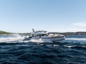 A sleek speedboat glides through the waves, showcasing its dynamic design and performance on the water.