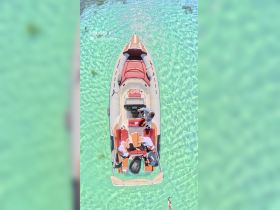 A group enjoys a relaxing moment aboard a boat in crystal-clear turquoise waters, perfect for a day of fun and adventure on the water.