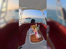 A beautifully arranged table of snacks and drinks on a boat, perfect for enjoying a day on the water with friends or family.