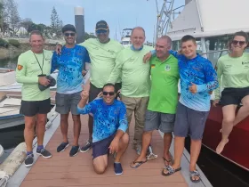 A cheerful group poses together on the dock, celebrating their boating adventure — perfect for capturing memories of fun times on the water.