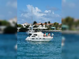 A lively group enjoys a day on the water aboard a boat, perfect for celebrations and gatherings in a beautiful coastal setting.