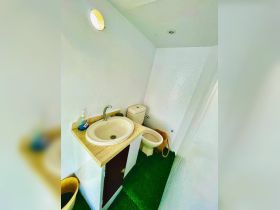 A clean and well-maintained bathroom inside a boat, featuring a sink and toilet, ideal for comfort during voyages.