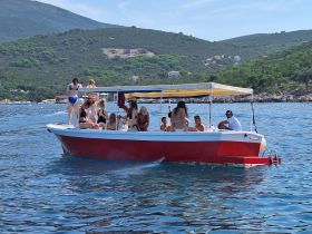 A lively group enjoys a summer day on a boat, showcasing fun and camaraderie on the water.
