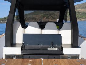 A sleek interior view of a boat's helm area featuring modern seating and a functional console, perfect for navigating the open waters.