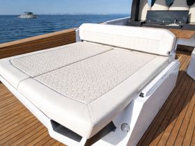 A stylish lounge area on a boat featuring a comfortable seating arrangement, perfect for relaxing on the water.