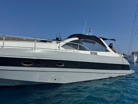 A sleek yacht is docked in clear blue waters, showcasing its elegant design and structure. Perfect for luxury charters and seaside adventures.