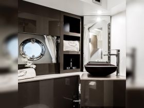 A sleek and modern bathroom interior of a boat, featuring elegant design elements and a stylish sink, perfect for luxury cruising experiences.