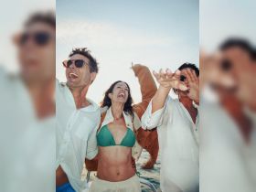 A lively group enjoys a fun moment on a boat, celebrating with laughter and joy under the sun — perfect for unforgettable boat parties.